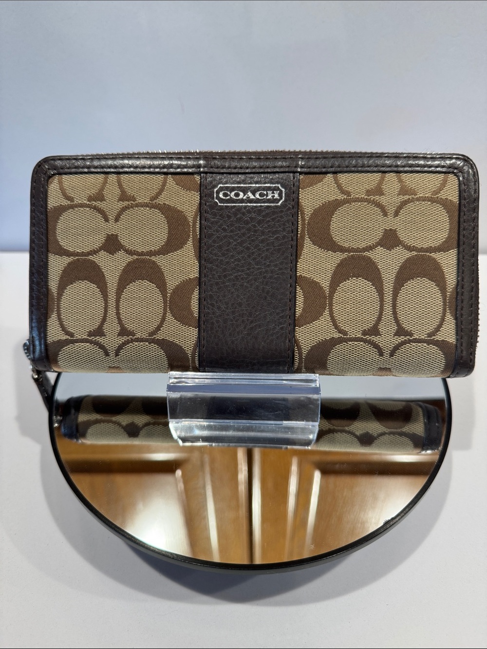 Coach Brown/Tan Signature Zip Wallet with Logo Plaque tags inside.